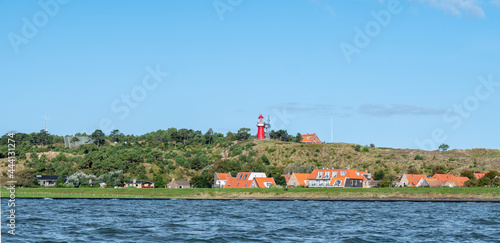Vlieland with Vuurduin lighthouse on vuurboetsduin and East-Vlieland town from Waddensea, Friesland, Netherlands photo