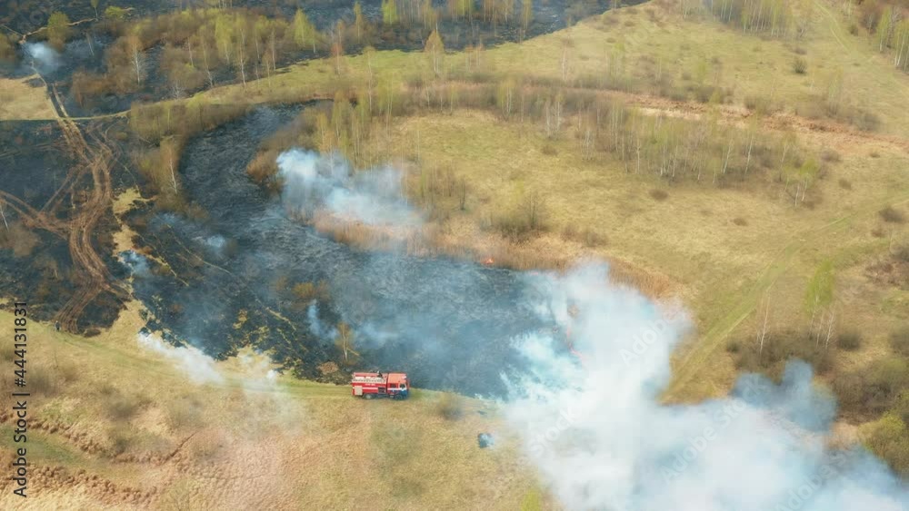 4K Aerial View Spring Dry Grass Burns During Drought Hot Weather. Bush Fire And Smoke. Fire Engine, Fire Truck On Firefighting Operation. Wild Open Fire Destroys Grass. Ecological Problem Air 4K Aerial View Spring Dry Grass Burns During Drought Hot Weather. Bush Fire And Smoke. Fire Engine, Fire Truck On Firefighting Operation. Wild Open Fire Destroys Grass. Ecological Problem Air