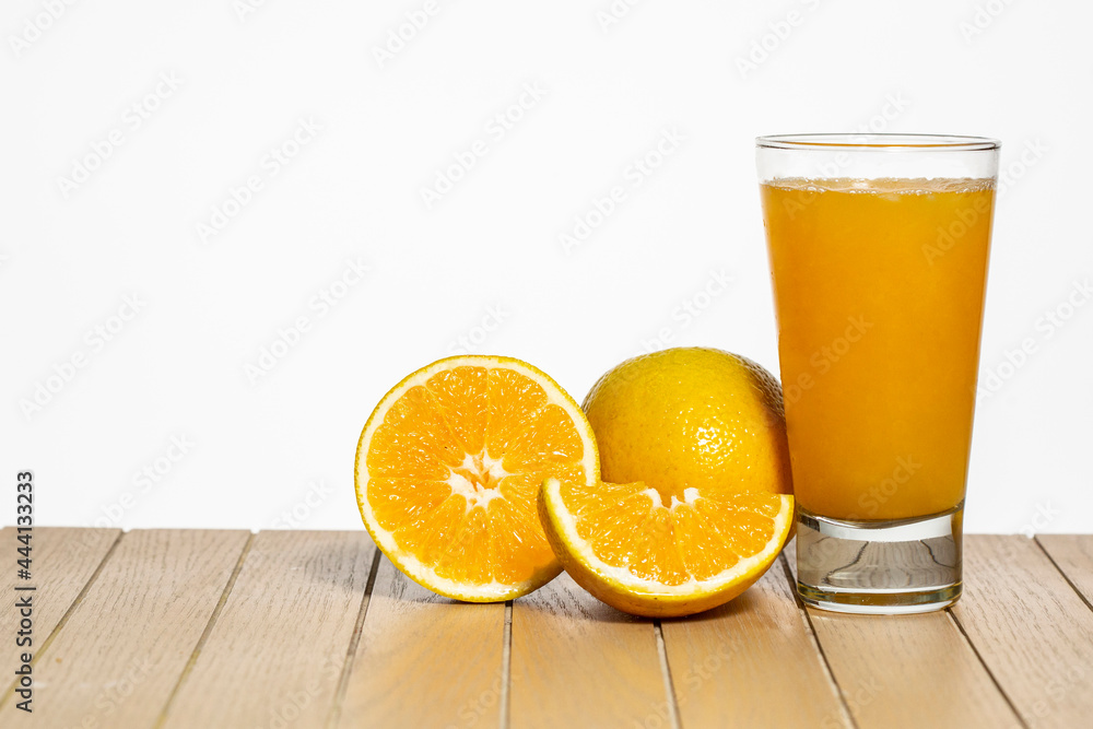 Glass with orange juice on table on white background Glass with orange juice on table on white background
