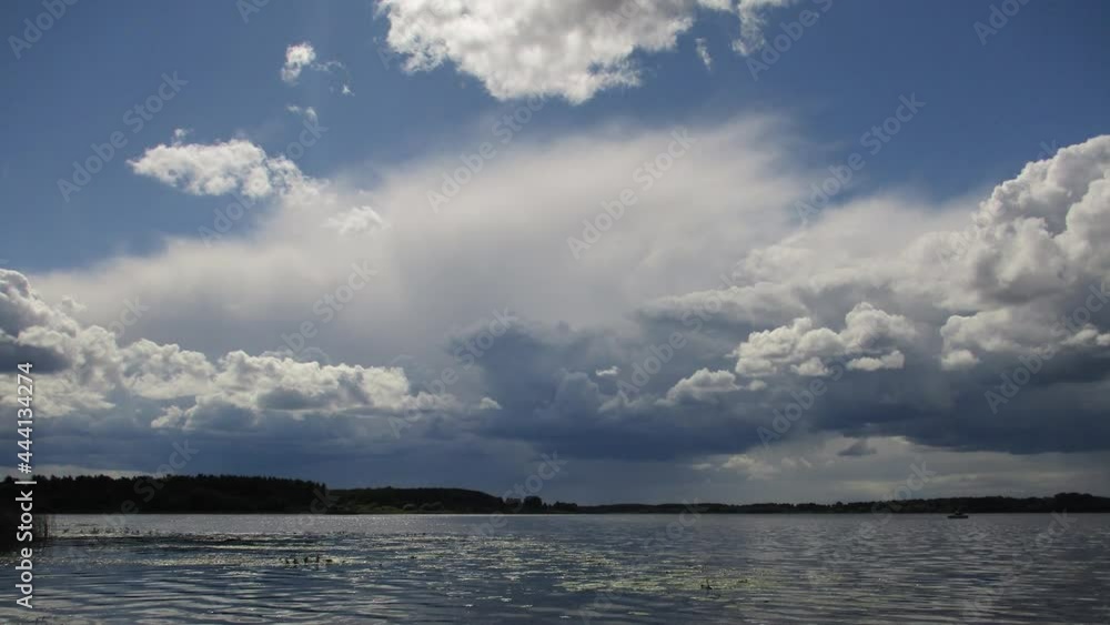 Sunny day. Clouds over the lake Sunny day. Clouds over the lake