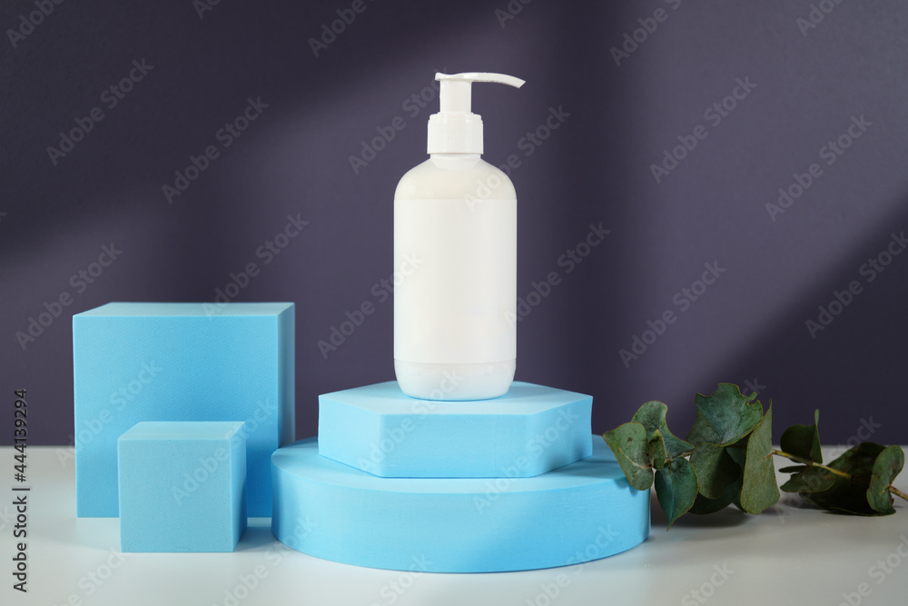 Cosmetic skincare container blank mockups in modern navy and blue styled setting with on trend shadow photography. Cosmetic skincare container blank mockups in modern navy and blue styled setting with on trend shadow photography.