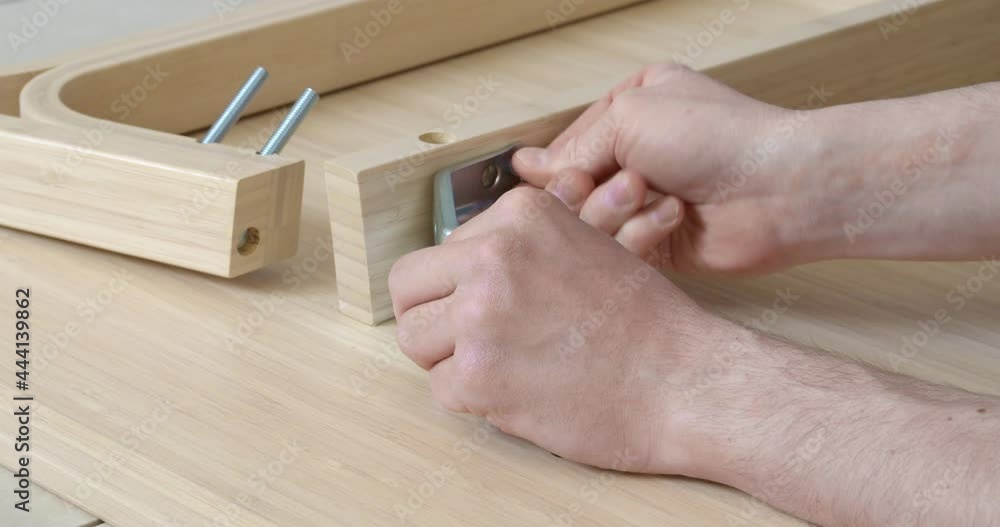 Man assembling furniture at home, closeup Man assembling furniture at home, closeup