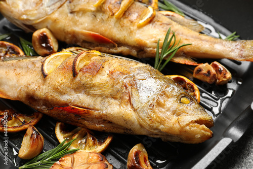 Tasty homemade roasted perches on grill pan, closeup. River fish