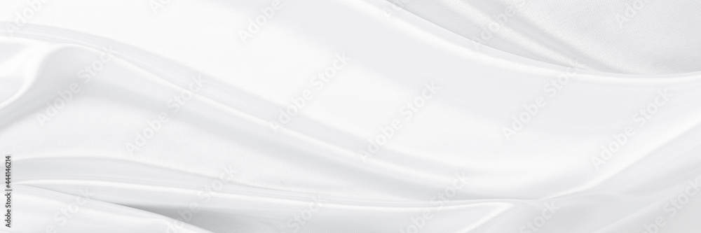 White gray satin texture that is white silver fabric silk panorama background with beautiful soft blur pattern natural.