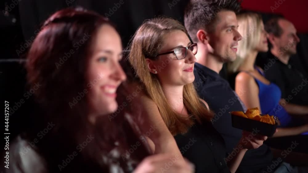 Young people in a movie theater enjoying a film - people photography Young people in a movie theater enjoying a film - people photography