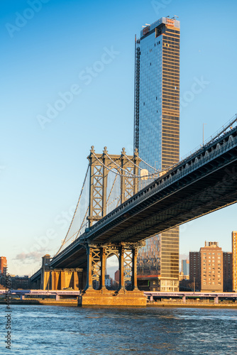 Manhattan, New York, 27 Dec 2018: people on Brooklyn bridge walkway and buildings in downtown Manhattan, One of the most iconic bridges in the world