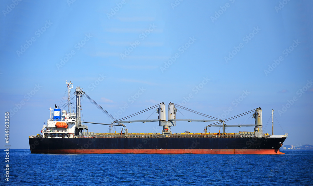 Container ship carrying container box in import export with quay crane, Global business cargo freight shipping commercial trade logistic and transportation oversea worldwide by container vessel.