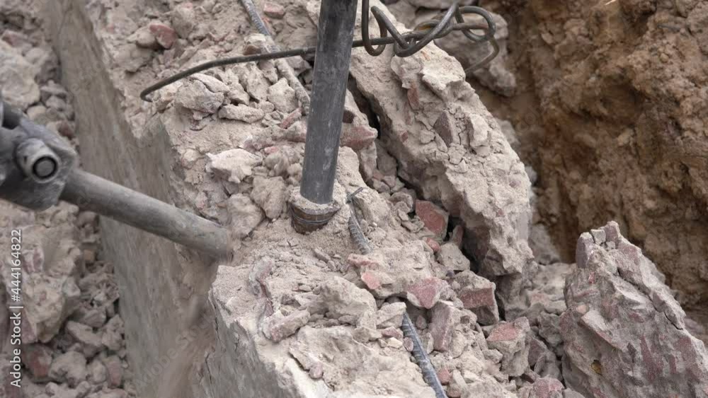 Demolishing an old concrete slab with a jackhammer Demolishing an old concrete slab with a jackhammer