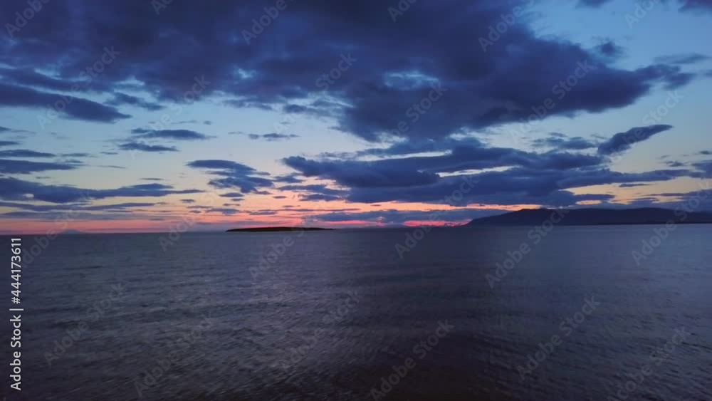 Aerial drone shot over ocean at sunset Aerial drone shot over ocean at sunset