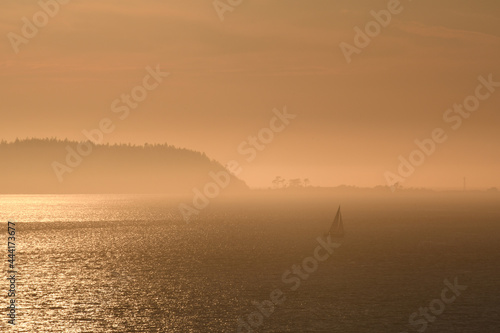 Sailboat in the misty islands at dusk