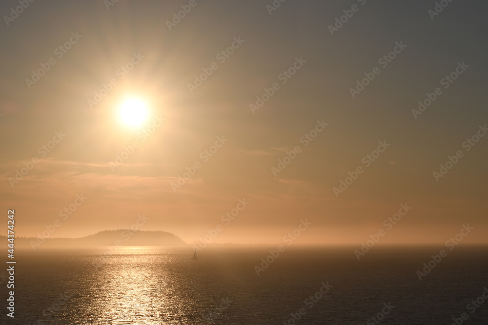 Sunset over an island shrouded with mist