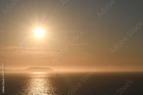 Sunset over an island shrouded with mist