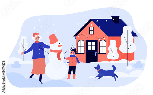 Grandma and grandson making snowman together in backyard. Flat vector illustration. Old woman, child, dog having fun under snowfall. Family, winter, Christmas, holidays, childhood concept for design