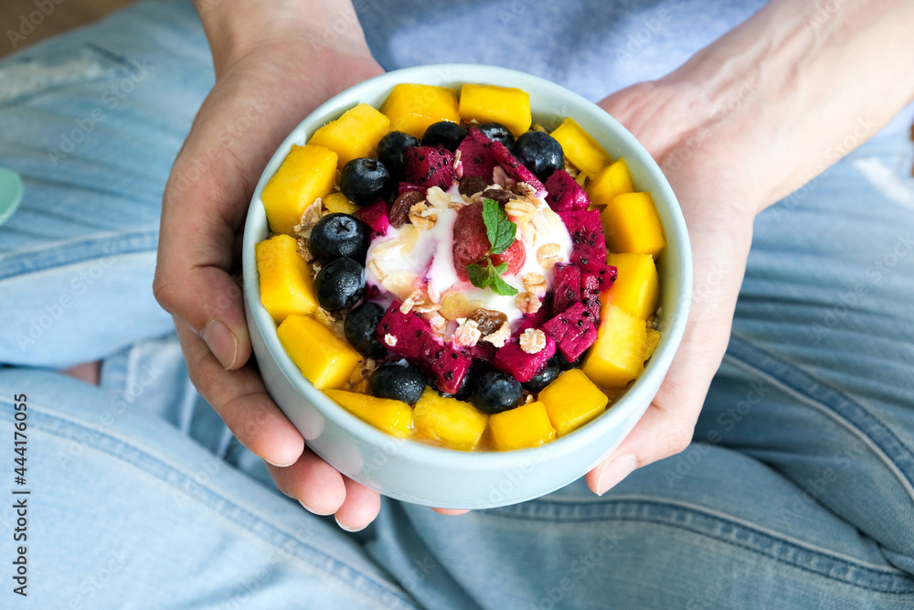 Hand of woman holding bowl of fresh strawberry and yogurt .Concept of healthy diet and weight control. Hand of woman holding bowl of fresh strawberry and yogurt .Concept of healthy diet and weight control.