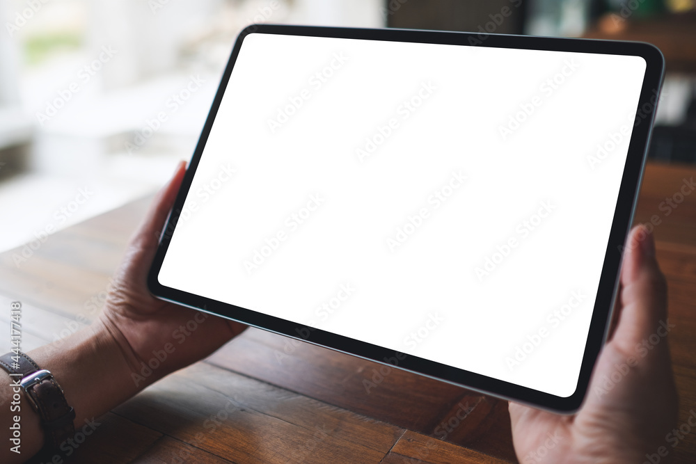 Mockup image of a woman holding digital tablet with blank white desktop screen Mockup image of a woman holding digital tablet with blank white desktop screen