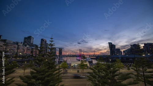 Sunset timelapse video of Bolte Bridge with Melbourne Star Observation Wheel at District Docklands in Melbourne CBD, Australia