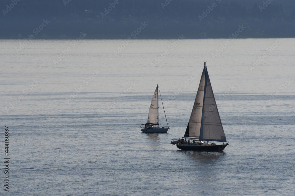 Two sailboats in the ocean close up