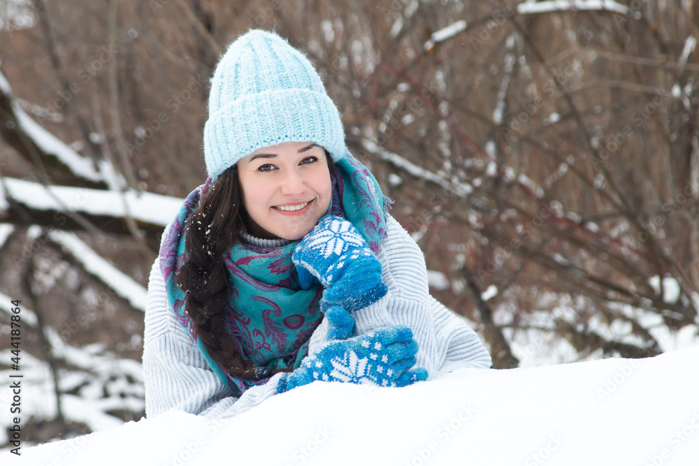 Fototapeta premium happy woman in winter rejoices in snowfall