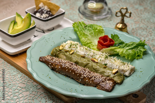 Desayuno especial de variedad de enchiladas (mole poblano, mole verde, salsa blanca) acompañadas de lechuga, aguacate y frijoles refritos