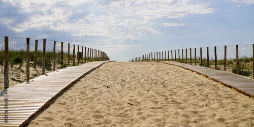 wooden path coast access with sand beach waves entrance to ocean atlantic sea in cap-ferret france