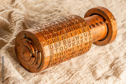 Opened copper cryptex invented by Leonardo da Vinci from the book da vinci code. Word creativity as password set by letters rings. Cryptographic equipment printed on a 3D printer.