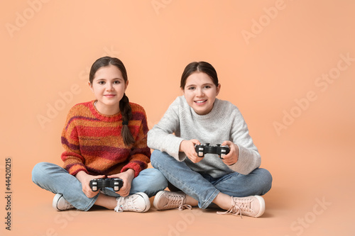 Cute twin girls playing vid...
