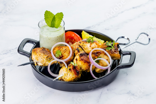 Chicken Tikka served on skewers photo