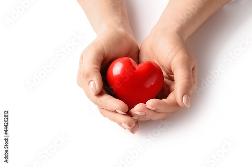 Fototapeta Naklejka Na Ścianę i Meble -  Female hands with red heart on white background