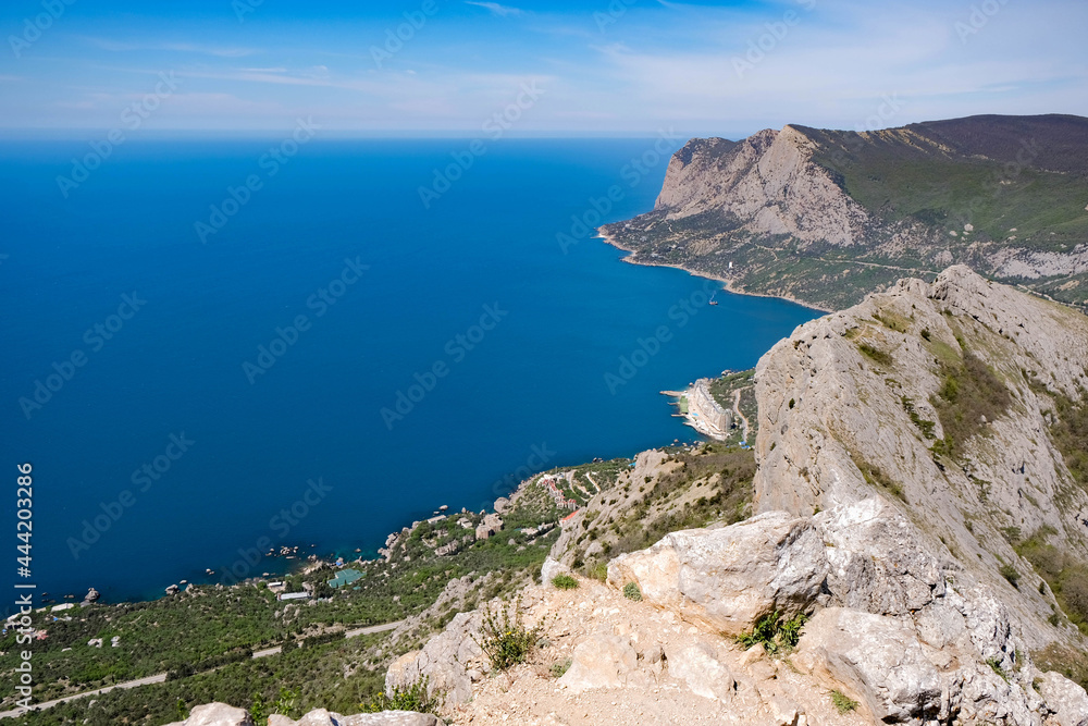 Panoramic view of blue sea, sky and mountains. Travel concept.