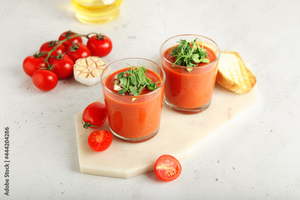 Glasses with tasty gazpacho on light background Glasses with tasty gazpacho on light background