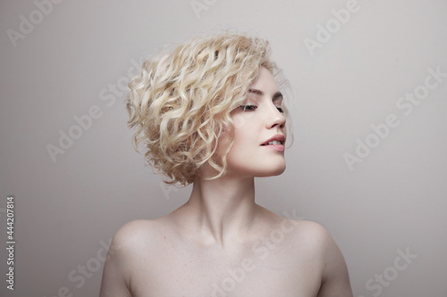 Headshot of gorgeous attractive young lady with curly hair smiling. Marilyn Monroe