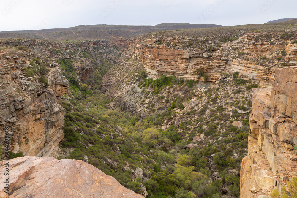 View down into the Valley from the Nieuwoudtville Waterfall on the Bokkeveld Plateau in the Northern Cape of South Africa View down into the Valley from the Nieuwoudtville Waterfall on the Bokkeveld Plateau in the Northern Cape of South Africa