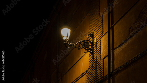 Street lamp on a brick wall at night