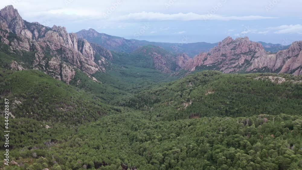 Aerial view of rocky mountain valley and summer landscape of nature. Nobody nature landscape. Rocky canyon, in a cloudy day, green vegetation, forest, trees. Aerial view of rocky mountain valley and summer landscape of nature. Nobody nature landscape. Rocky canyon, in a cloudy day, green vegetation, forest, trees.