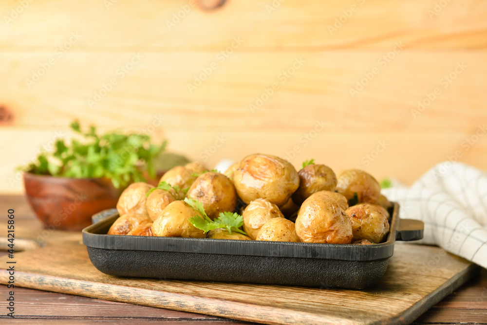 Dish with tasty baked potato on table Dish with tasty baked potato on table