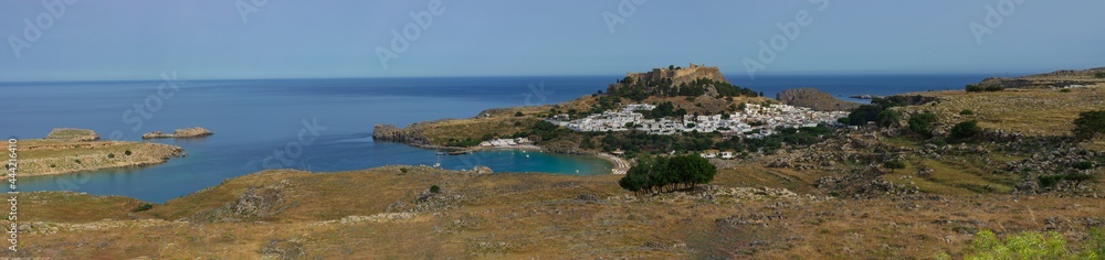 Beautiful panorama of the ancient city and acropolis of Lindos on the Mediterranean coast (Rhodes, Greece)