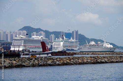 Cruiseship cruise ship liner in port of Hongkong Hong Kong, China with Kai Tak cruise terminal and city skyline photo