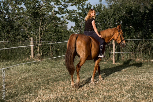 Beautiful rider with long hair riding horse on horse ride . Beauty and health. Life in nature. Active recreation. Role model.