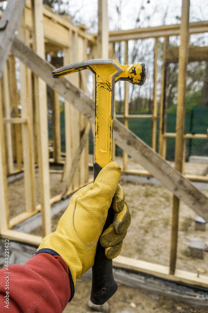 House hammer . Frame hammer in carpenter's hand House hammer . Frame hammer in carpenter's hand
