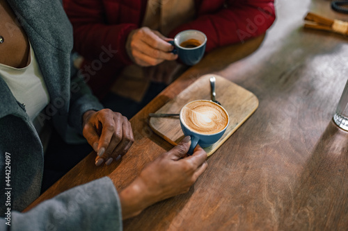 Picture of coffee cups, being picked up from the table.