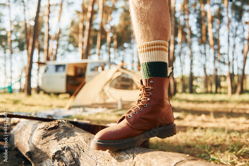 Close up view of legs. Man is traveling alone in the forest at daytime at summer