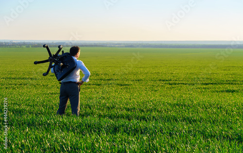 businessman carries an office chair in a field to work  freelance and business concept  green grass and blue sky as background