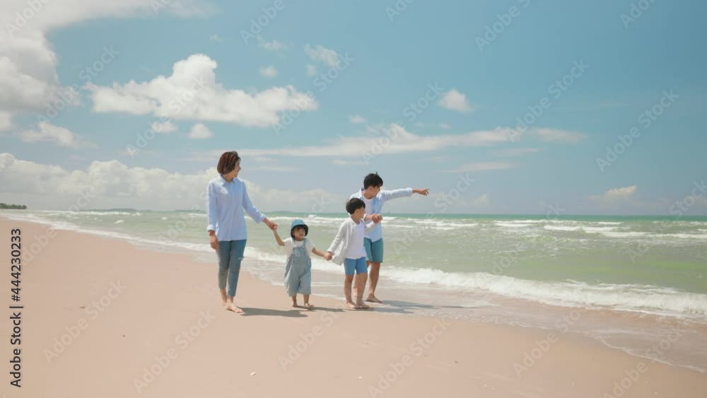 Asian father and mother play with child and walking along the beach Asian father and mother play with child and walking along the beach
