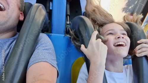 dad and daughter ride extreme attraction. adrenaline and fun in amusement park