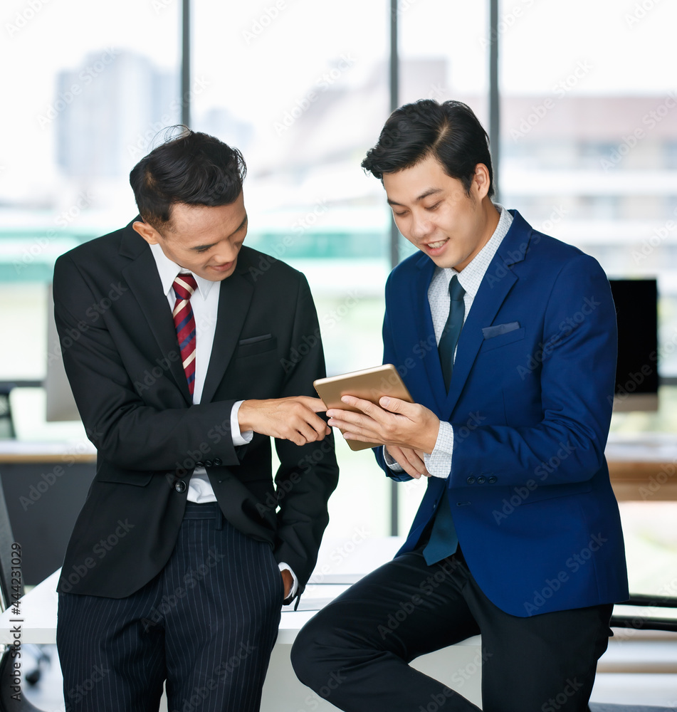 Ethnic businessmen using tablet in office