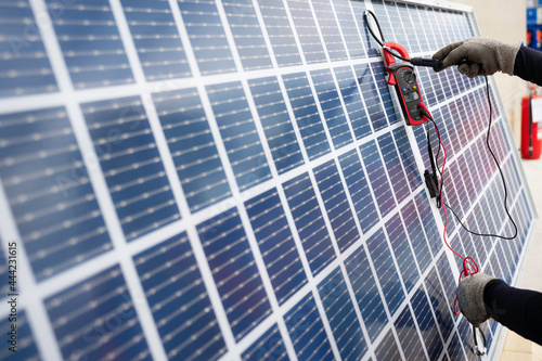 Worker used a meter for checking the readiness of the solar panel to confirming function normally before installation. Solar panels installation process.