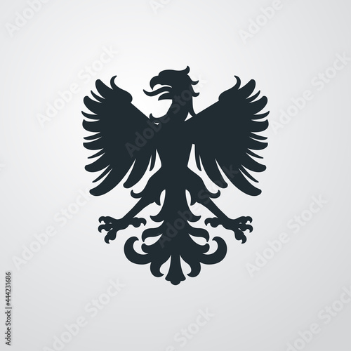 Logo heráldica con silueta de águila medieval de pie en fondo gris