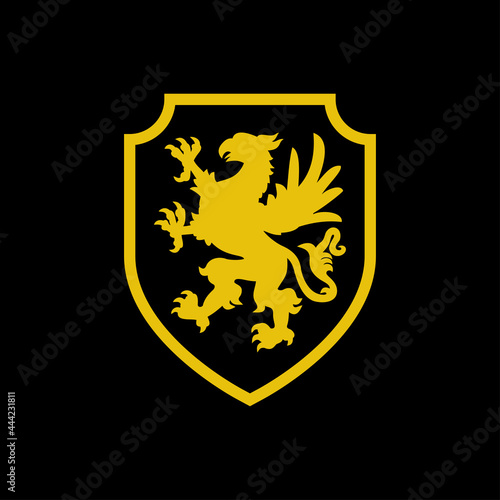 Logo heráldica con silueta de grifo medieval de pie en escudo de color amarillo y fondo negro