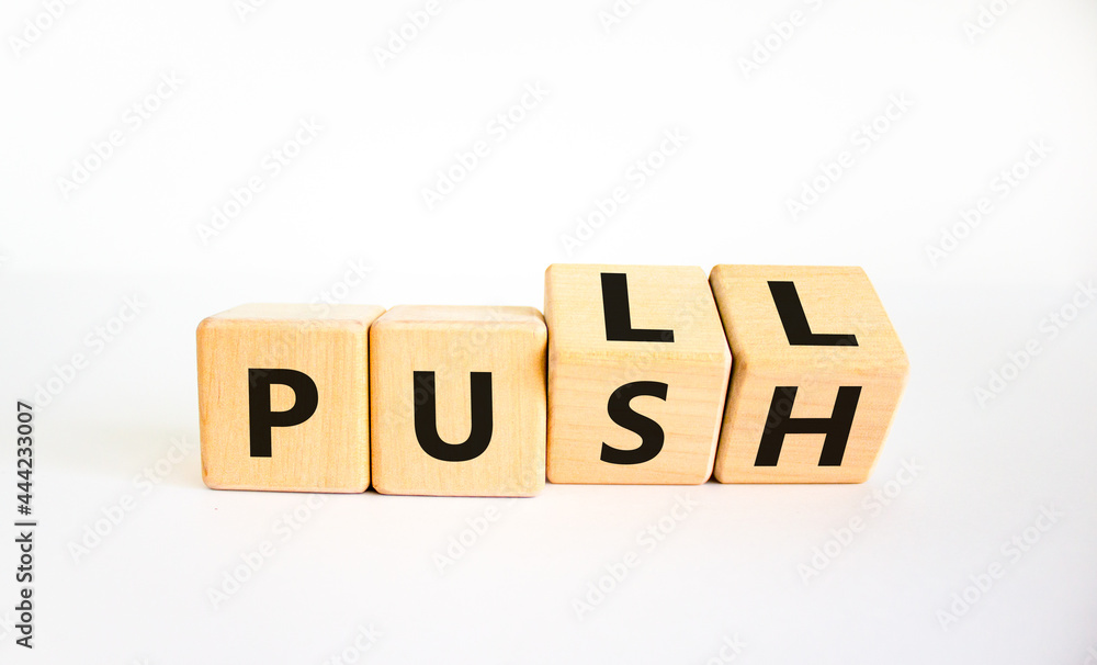 Pull or push symbol. Turned wooden cubes and changed the word 'push' to 'pull'. Beautiful white background, copy space. Business and pull or push concept. Pull or push symbol. Turned wooden cubes and changed the word 'push' to 'pull'. Beautiful white background, copy space. Business and pull or push concept.