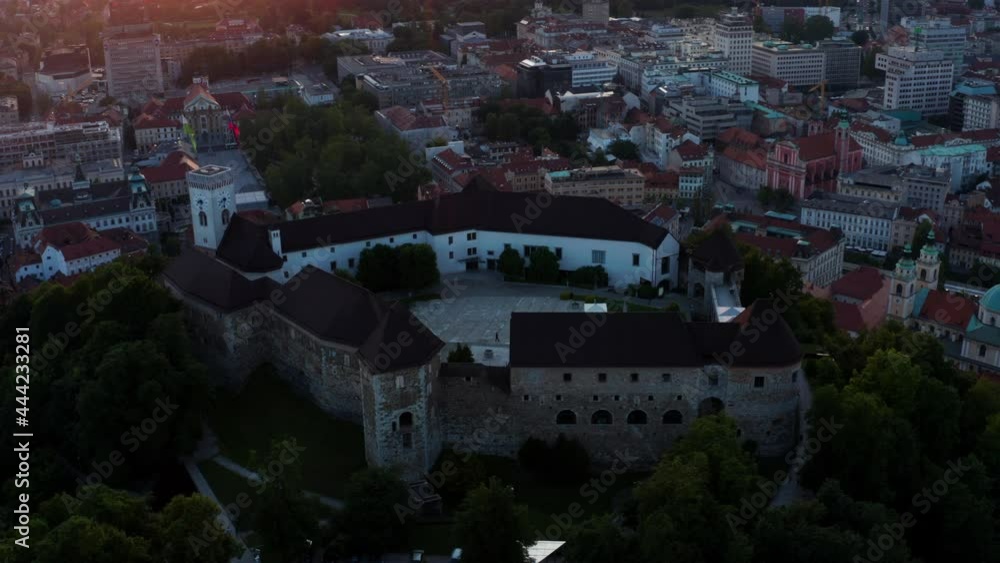 Bird's Eye View Of Ljubljana Castle At The Hilltop Within The Cityscape At Dusk In Ljubljana , Slovenia. aerial Bird's Eye View Of Ljubljana Castle At The Hilltop Within The Cityscape At Dusk In Ljubljana , Slovenia. aerial